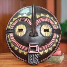 a wooden mask sitting on top of a table