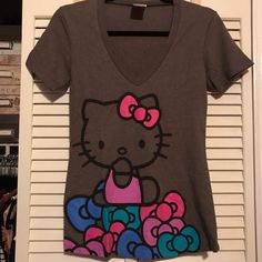 a women's shirt with an image of a hello kitty on it