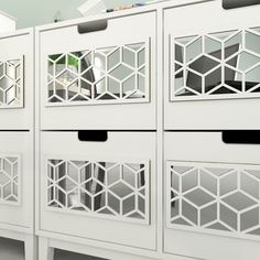 several white storage cabinets with mirrors on them