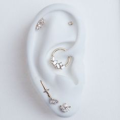 a pair of ear piercings sitting on top of a white surface