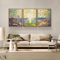 two paintings hang above a couch in a living room