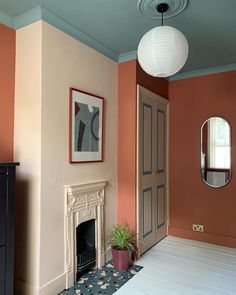 a living room with a fireplace and mirror