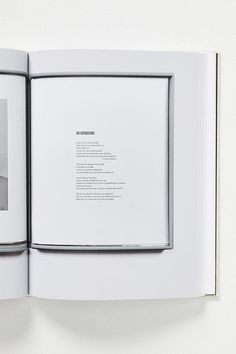 an open book with black and white photos on the cover, in front of a white background