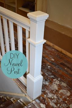 a white railing with a blue sign that says diy newel post