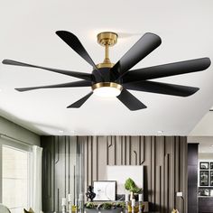 a ceiling fan with three black blades in a living room