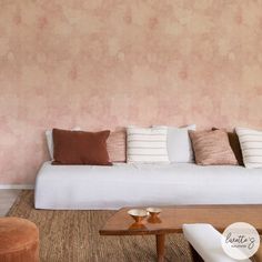 a living room filled with furniture and pink walls