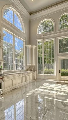 a large kitchen with marble floors and white cabinets