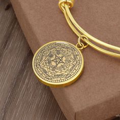 "This Seal of the True God Bracelet Is the Perfect Gift Whether for Yourself or a Loved One.  Explore all our Witchcraft jewelry here: https://www.etsy.com/in-en/shop/SymbolicPresent?ref=seller-platform-mcnav&section_id=22613465 ➜ Our jewelry is made of high-quality surgical steel with a shatterproof liquid glass coating and an 18k gold finish option. ➜ Engrave onto the back of the Sigillum Dei Aemeth pendant your loved one's name, your wedding date, an anniversary, or anything else you want to Spiritual Engraved Charm Bracelet Gift, Spiritual Engraved Charm Bracelet For Gift, Symbolic Etched Bangle Jewelry, Symbolic Engraved Charm Bracelet As Gift, Symbolic Engraved Charm Bracelet Gift, Symbolic Engraved Charm Bracelet For Gift, Spiritual Gold Pendant Bracelets, Spiritual Gold Pendant Bracelet, Gold Spiritual Pendant Bracelet