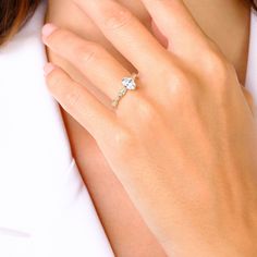 a woman's hand with a diamond ring on it