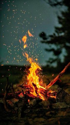 a campfire with lots of fire and sparks coming from it's top burn