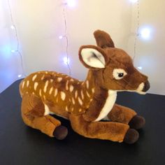 a stuffed deer sitting on top of a table