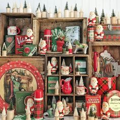 an assortment of christmas items on display in a room with wooden crates and other decorations