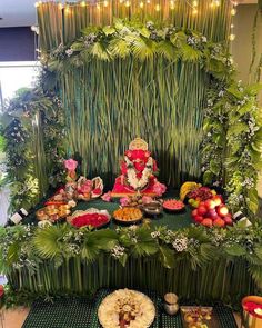 an arrangement of fruits and vegetables on display in front of a gandap decoration