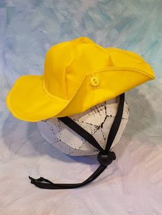 a yellow hat sitting on top of a white ball