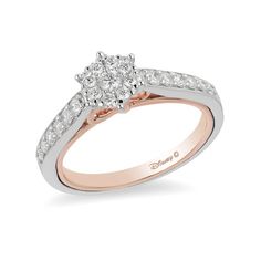 a white and rose gold engagement ring with diamonds on the shoulders, set in two tone gold