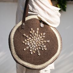 a woman carrying a brown and white purse