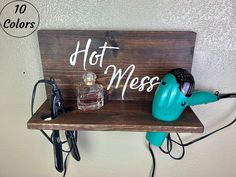 a wooden sign that says hot mess with some hair dryers and other items on it