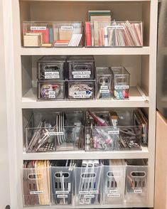 an organized pantry with plastic bins and clear containers