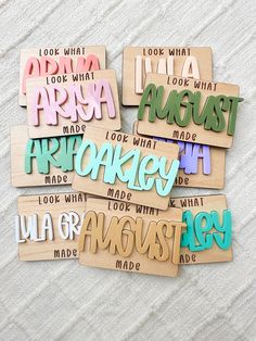 several wooden magnets with words on them