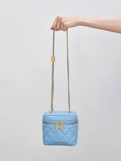 Commanding attention with its vibrant light blue hue, our Nezu bag is a heavyweight when it comes to both style and function. Elegant with classic quilting and featuring a hint of gold-toned hardware, it will make the perfect outfit companion for evening events or soirees. It also doubles up as a vanity case that will keep your cosmetics and toiletries safe and organised on your holiday trips and staycations. Boxy Bags, Vanity Case, How To Finish A Quilt, Charles Keith, Bag Light, Holiday Travel, Blue Hues, Bag Straps, Cloth Bags