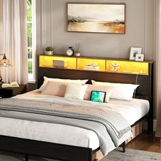 a bedroom with a bed, nightstands and pictures on the wall