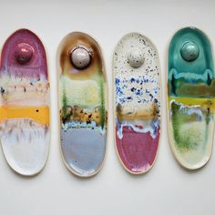 three skateboards with different designs on them and one has a ball in the middle