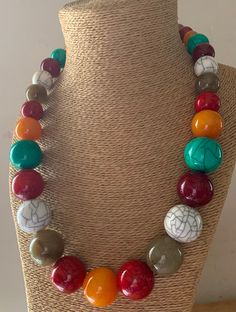 This Long Handbeaded Necklace is made with multicoloured resin beads; The colours are; Mango Orange, Red Crackle, Natural grey, White crackle, Turquoise, Maroon.  The beads vary in size, the largest at the centre of the necklace and taper to the screw fastening. The screw fastening is integrated inside the bead. No metal touches the skin. Measurements: Length: 66 cm. Largest Bead: 2.5 cm. Smallest bead: 1 cm. HANDMADE & FAIRTRADE Your necklace will be dispatched by Royal Mail 1st Class UK Standa Multicolor Resin Bead Jewelry, Bohemian Multicolor Round Beads, Resin Beaded Necklaces With Round Beads For Gifts, Resin Beaded Necklaces With Round Beads As Gift, Multicolor Wooden Beads Jewelry, Multicolor Wooden Round Beads Jewelry, Multicolor Wooden Beaded Jewelry, Multicolor Wooden Round Bead Jewelry, Colorful Round Beaded Resin Jewelry