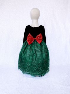 A gorgeous dress that can be worn for a Christmas party, birthday, photoshoot, or pageant! Long sleeve bodice is made out of soft velvet. The zipper can be found on the back of the dress. Comes with a detachable embroidery bow. The skirt is made out of a detailed embroidery fabric with lining underneath. One last layer of lining with crinoline attached underneath everything to give the dress shape. *Mannequin has petticoat to show detail. !PETTICOAT NOT INCLUDED! LINK TO PURCHASE PETTICOAT: http Green Embroidered Dress For Dress-up, Embroidered Fitted Princess Dress For Party, Fitted Embroidered Princess Dress For Party, Green Princess Dress For Holiday Party, Elegant Holiday Princess Dress For Celebration, Elegant Princess Dress For Holiday Celebration, Festive Black Celebration Dress, Green Princess Dress For Christmas Party, Princess Dresses For Holiday Season