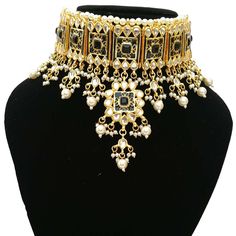 "Simple Fancy Bridal Wedding Designer Meena Kundan necklace Set Contains a awesome choker necklace that Fixs the Neck, a Pair of Earrings embedded with Semi-precious Stones like Pearl,glass. This product is handmade & hence the product can be non-uniform & vary in color & texture. Color : Black Gorgeous Meena Kundan Gold Plated Necklace jewelry Set 1.Set consists of Necklace, Earrings 2. Necklace Size:(4\"L X 6.5\"W) 3.Necklace Weight: 150 Gm 4.Earrings Length:2\" EXPEDITED DELIVERY Heavy Pearl Necklace For Weddings And Festivals, Bollywood Heavy Choker For Wedding, Bollywood Bridal Kundan Necklace Jeweled, Bollywood Style Kundan Bridal Necklace With Jewels, Bollywood Style Bridal Kundan Necklace Jeweled, Bollywood Style Kundan Bridal Necklace, Bollywood Style Bridal Kundan Necklace, Bollywood Style Jeweled Bridal Necklace For Reception, Bollywood Style Jeweled Bridal Necklace