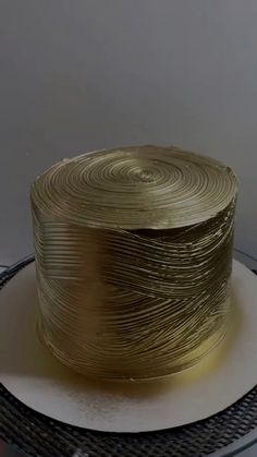 there is a cake that has been made to look like it's wrapped in gold foil