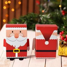 two christmas boxes sitting on top of a wooden table