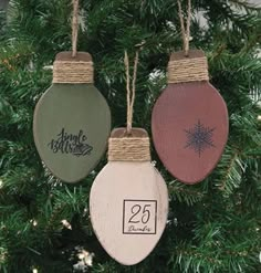 three ornaments hanging from a christmas tree with the numbers twenty five and twenty six on them