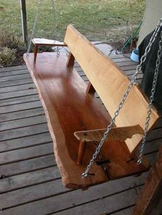 a wooden swing with chains hanging from it