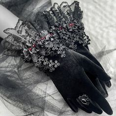 Elevate your style with my Black Velvet Gothic Victorian Short Gloves featuring Lace Accents and delicate beads. Meticulously designed for a touch of dark romance, these gloves, crafted from luxurious black velvet, exude sophistication. The intricate lace accents, adorned with subtle beads, add a graceful charm, capturing the essence of Victorian elegance. Perfect for those who appreciate unique accessories, these gloves are an exquisite addition to your wardrobe. Make a statement with a blend of gothic allure and refined style. Embrace the mystique and adorn your hands with these beautifully crafted gloves. Glove size - one size , fits approximately up to 17 cm/ 6.69 inches of wrist circumference. GALIS JEWELRY DESIGNS Visit my shop homepage here: https://www.etsy.com/shop/GalisJewelryDes Gothic Fashion Accessories, Victorian Fashion Accessories, Black Gloves Aesthetic, Aesthetic Gloves, Luxury Goth, Goth Gloves, Dark Accessories, Gothic Gloves, Victorian Gloves