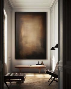 an empty room with a large painting on the wall