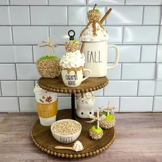 three tiered tray with coffee mugs, marshmallows and other treats