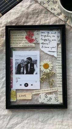 an old photo frame with music notes, flowers and a guitar