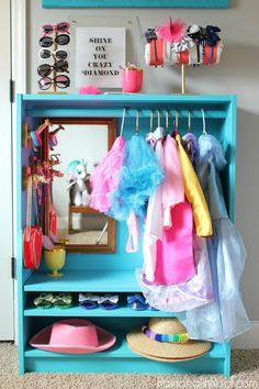 a blue shelf with clothes hanging on it