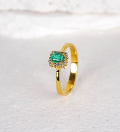 "Rectangular Emerald Vintage Bezel Halo Ring/ Emerald Cut Emerald  Ring/ Columbian Emerald with Diamonds/ Gifted Ring For Her/ Christmas Gift I especially prefer minimal designs and love to create or produce them. They can fit in our daily life and we easily can integrate and be whole with them. This lovely Columbian Emerald Ring with Diamonds is to be with you in your everyday wear, to be whole, to become you.  Features *Made to Order.  *Made in Turkey. *14K Solid Gold *Custom Gold Color: Rose Gold, Yellow Gold, White Gold *Total CTW: 0.35 Carat *Width of Band: 1.40MM *Setting Type: Prong center stone with bezel side stone - Halo Ring *Natural Earth-Mined & Non-Conflict Diamonds *Ready to Ship in 1 Week *Center Stone Specifications:        oShape: Rectangular (Emerald Cut)        oWeight: Luxury Gold Emerald Ring With Halo Design, Gold Emerald-cut Cluster Ring With Halo Design, Gold Emerald-cut Halo Cluster Ring, Gold Emerald Cut Cluster Ring With Halo Design, Gold Emerald Cut Halo Cluster Ring, Gold Emerald Ring With Halo Design As Gift, Square Cut Emerald Rings In Gold, Square Cut Emerald Gold Rings, Luxury Gold Square Cut Emerald Ring