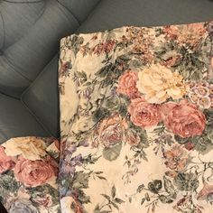 an upholstered chair with floral fabric on it