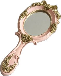 a pink and gold mirror with roses on the rim is shown against a white background