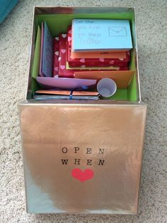 an open box filled with assorted items on top of a white carpeted floor