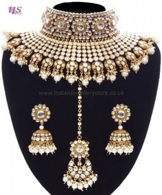 Dramatic designer Indian jewellery set in antique gold (bright gold colour with black antique) & white; bejewelled with pearl & gleaming kundan stones. This Pearl Sabyasachi Inspired Bridal Jewellery Set emulates the jewellery designs by this style icon. The lavish choker seamlessly flows onto the chest for a truly regal look. This kundan in this piece is truly stunning and at an amazingly low price for the quality, this set is a total must have for fashionistas and this season's Asian brides! Dimensions are as follows (at widest points): Statement designer necklace - 4.0cm wide falls a further 6.5cm. Jhumki Indian earrings - stud 2.5cm wide, jhumki 3.5cm wide, overall earring length - 7.5cm. Indian Jewellery Set, Bridal Jewellery Set, Sabyasachi Jewellery, Bridal Choker, Pearl Bridal Jewelry, Jewelry Mirror, Designer Necklace, Indian Earrings, Jewellery Uk