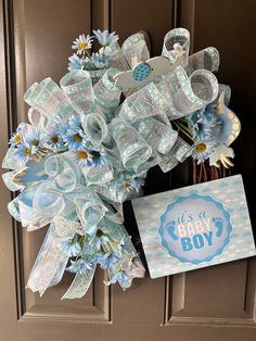 a baby boy wreath with blue and white flowers