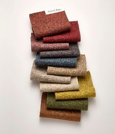 a pile of different colored tweed fabric on top of each other in various sizes and colors