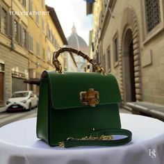 This bag has been made of the best genuine leather by local master crafters of Florence in Italy, designed for women who only accept premium Italian quality and luxury leather bags and modern Italian fashion. . Sizes: Width: 22 cm/8.75 inch Height: 16 cm/6.25 inch Depth: 7 cm/2.75 inch The story of this bag: As she walked down the streets of Florence, the woman couldn't help but feel a sense of awe at the beautiful architecture and stunning artwork all around her. She was on a trip to Italy with Light Luxury Leather Shoulder Box Bag, Light Luxury Leather Box Bag With Detachable Strap, Luxury Green Bag With Smooth Grain, Luxury Green Smooth Grain Shoulder Bag, Designer Green Bag With Leather Lining, Designer Green Leather Flap Bag, High-end Green Shoulder Bag As A Gift, High-end Rectangular Bag With Leather Lining, Luxury Green Bag With Leather Lining