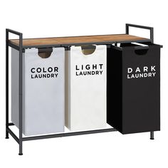 three color laundry bins with wood top and metal frame, one is black, the other is white