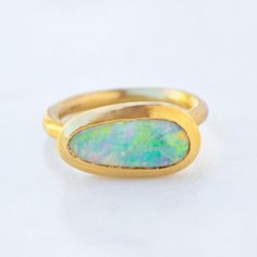 Our one of a kind Black Opal Forest Ring is set with a Lightning Ridge black opal. Opal measures 11 x 6mm. Band width 2mm. Pictured with a matte finish. For a high shine finish please leave a note at checkout. Please note, we will match the opal as close to the image as possible. Each opal is unique and may vary in appearance and colour from what is depicted on the site. Modern Round Opal Ring, Modern Oval Cabochon Opal Ring, Modern Oval Opal Ring, Modern Opal Ring For Anniversary, Forest Ring, Lightning Ridge Black Opal, Lightning Ridge Opal, Opal Ring Gold, Lightning Ridge