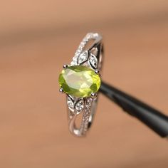 It is a natural peridot ring. The main stone is 6 mm*8 mm oval cut.weight about 1.33 carats.The basic metal is sterling silver and plated with rhodium.To change the metal to a solid gold (white/rose) or platinum is also available, please ask for a quotation if you want.You can also go to my shop Home for more elegant rings: https://www.etsy.com/shop/godjewelry?ref=hdr_shop_menu Peridot is the August birthstone.More peridot rings:https://www.etsy.com/shop/godjewelry?section_id=20709252Customizati Lime Green Oval Jewelry For May Birthstone, Lime Green Oval Rings With Accent Stones, Oval Peridot Birthstone Ring For May, Oval Peridot Birthstone Ring With Accent Stones, Oval Peridot Birthstone Ring For Anniversary, Oval Peridot Birthstone Ring In Fine Jewelry, Peridot Oval Birthstone Promise Ring, Oval Peridot Birthstone Ring, Oval Peridot Birthstone Promise Ring