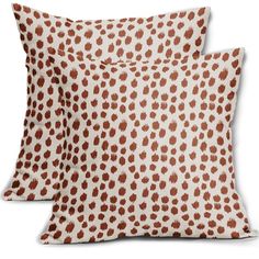 two brown and white pillows sitting next to each other